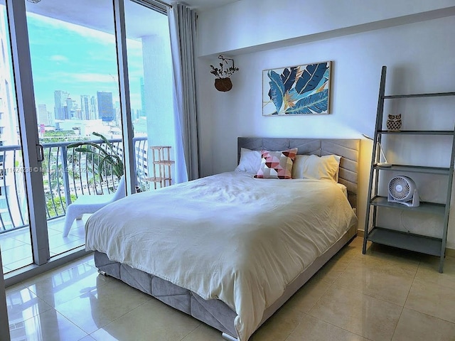 bedroom with light tile patterned flooring and access to outside