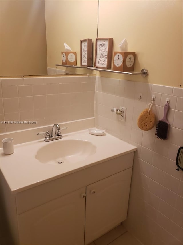 bathroom featuring vanity, decorative backsplash, and tile walls