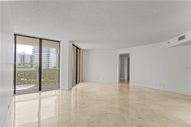 20185 E Country Club Dr Unit 502, Aventura, FL 33180 - spare room with a textured ceiling, visible vents, expansive windows, and marble finish floor