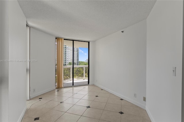 20185 E Country Club Dr Unit 502, Aventura, FL 33180 - unfurnished room with baseboards, light tile patterned floors, a textured ceiling, and floor to ceiling windows