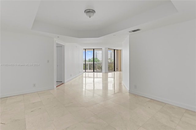 20185 E Country Club Dr Unit 502, Aventura, FL 33180 - spare room with a raised ceiling, visible vents, and baseboards