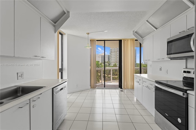 20185 E Country Club Dr Unit 502, Aventura, FL 33180 - kitchen with a wall of windows, a sink, appliances with stainless steel finishes, and light countertops