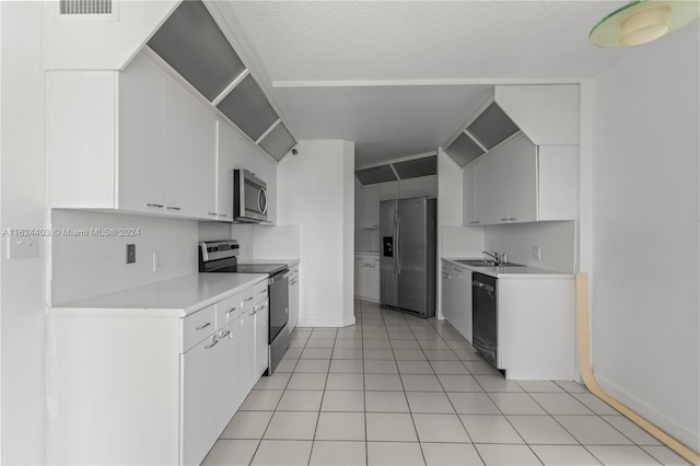20185 E Country Club Dr Unit 502, Aventura, FL 33180 - kitchen with a sink, stainless steel appliances, visible vents, light countertops, and white cabinets