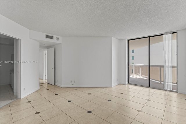 20185 E Country Club Dr Unit 502, Aventura, FL 33180 - empty room with baseboards, visible vents, a textured ceiling, and light tile patterned flooring