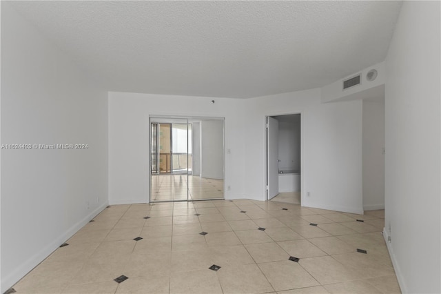 20185 E Country Club Dr Unit 502, Aventura, FL 33180 - unfurnished room featuring baseboards, visible vents, light tile patterned floors, and a textured ceiling
