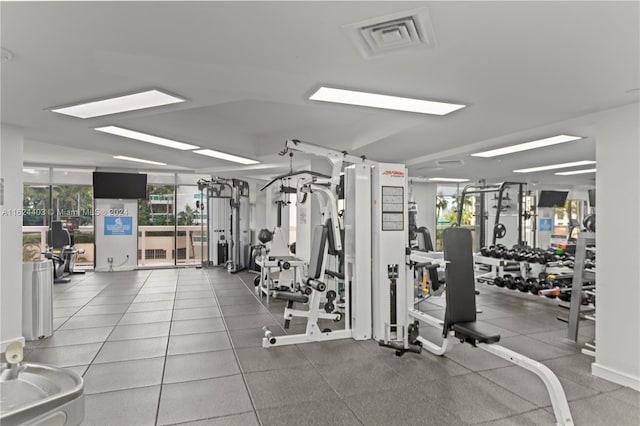 workout area with tile patterned floors and a healthy amount of sunlight