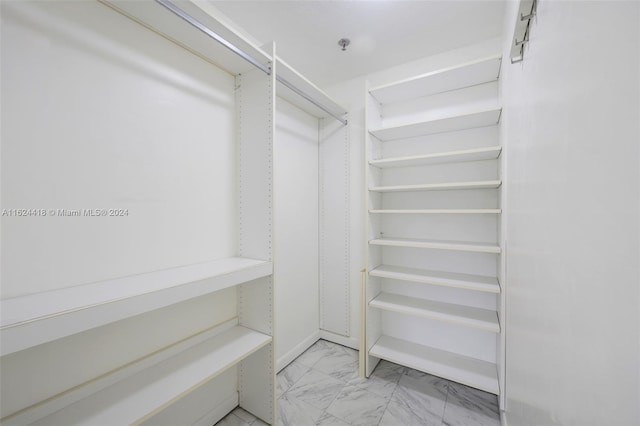 walk in closet featuring light tile patterned floors