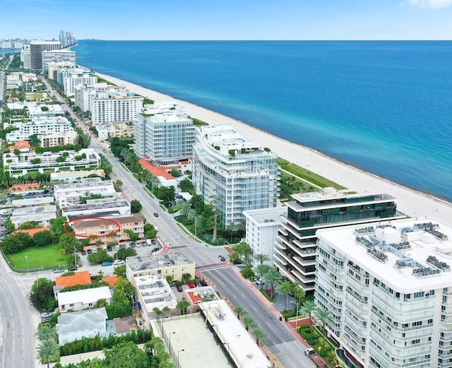 drone / aerial view featuring a beach view and a water view