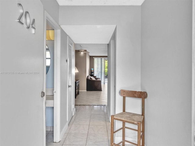 hall with light tile patterned floors