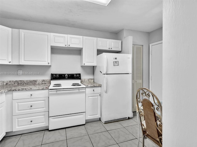 kitchen featuring white cabinetry, light tile patterned floors, and white appliances