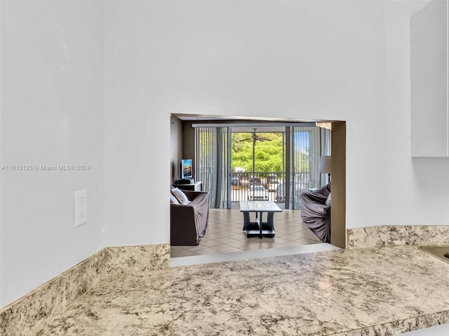 kitchen featuring a high ceiling and light tile patterned floors