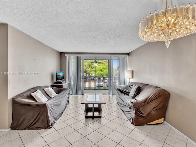 living room featuring an inviting chandelier, light tile patterned floors, and a textured ceiling