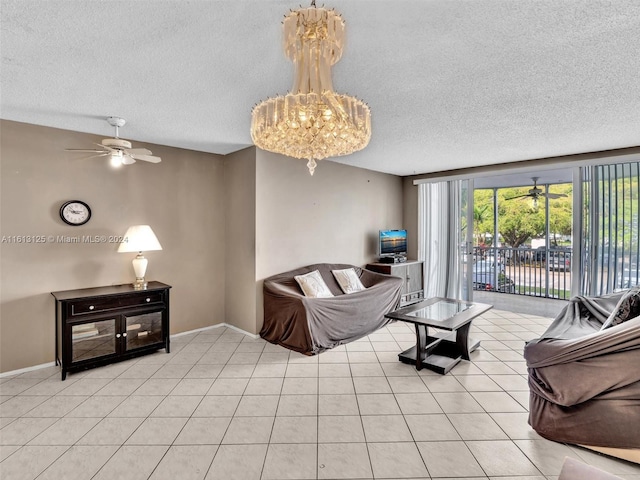 tiled living room with ceiling fan with notable chandelier and a textured ceiling