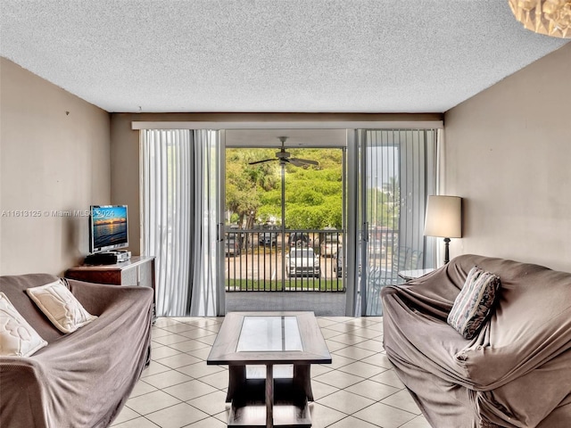 tiled living room with ceiling fan and a textured ceiling