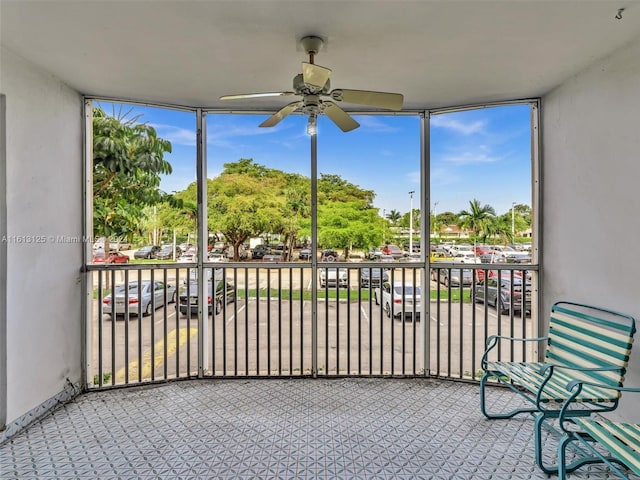 sunroom / solarium featuring a wealth of natural light and ceiling fan