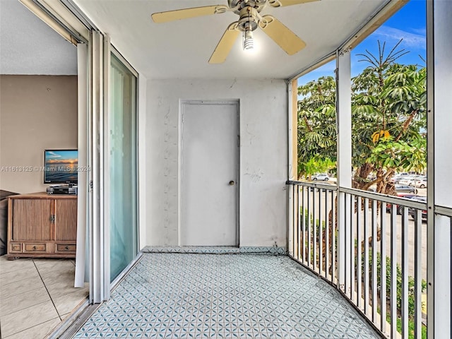 unfurnished sunroom featuring ceiling fan