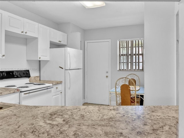 kitchen with white appliances and white cabinets