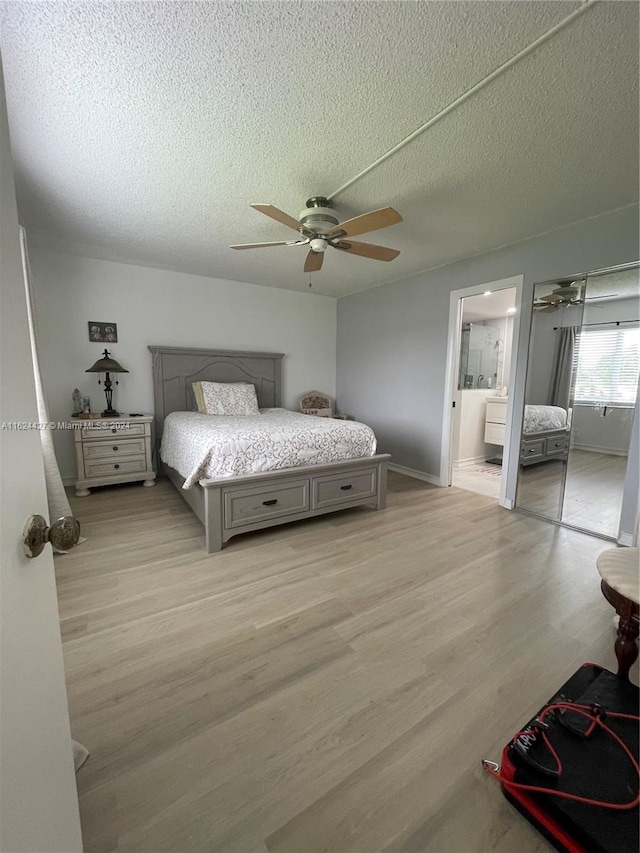 bedroom featuring a textured ceiling, ceiling fan, wood-type flooring, and connected bathroom