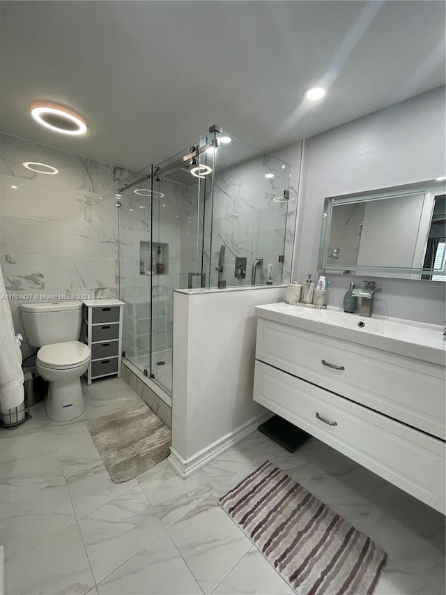 bathroom featuring vanity, an enclosed shower, tile patterned flooring, and toilet