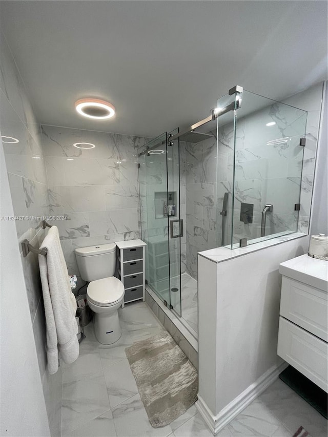 bathroom with walk in shower, toilet, vanity, tile walls, and tile patterned floors