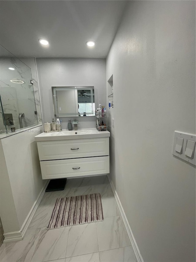 bathroom with vanity, a tile shower, and tile patterned floors