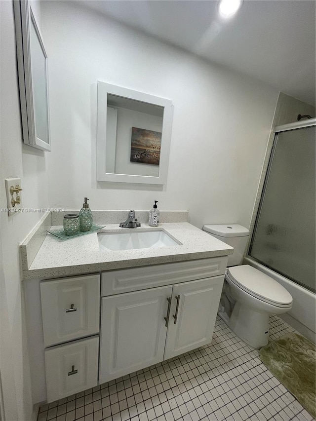 bathroom featuring vanity, tile patterned floors, and toilet