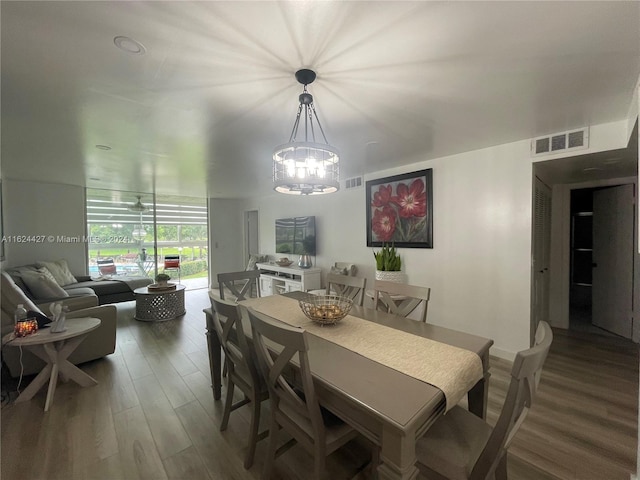 dining room featuring a notable chandelier and dark hardwood / wood-style floors