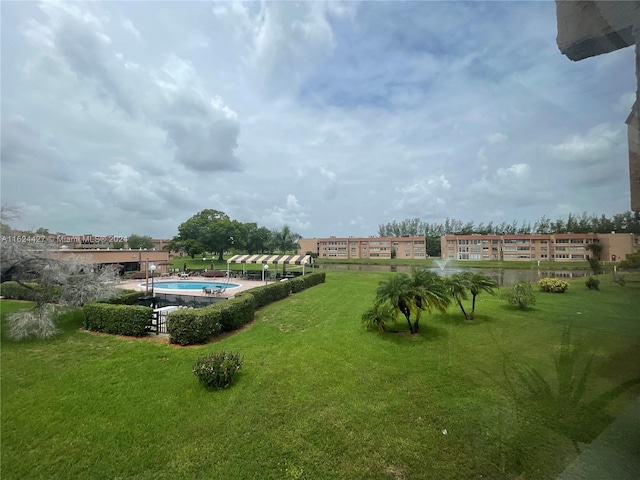 view of yard featuring a community pool