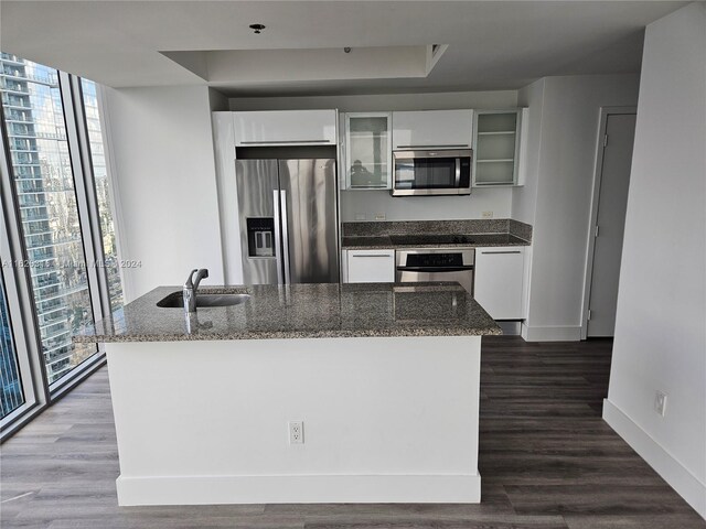 kitchen featuring white cabinetry, appliances with stainless steel finishes, hardwood / wood-style flooring, and sink