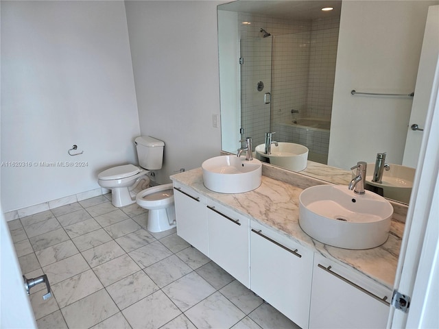 full bathroom featuring vanity, toilet, a bidet, and tiled shower / bath