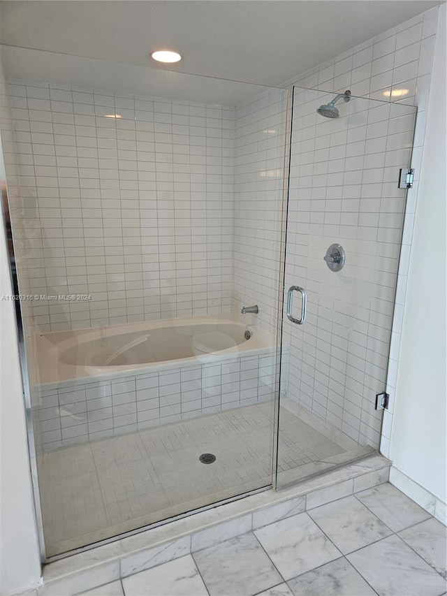 bathroom featuring independent shower and bath