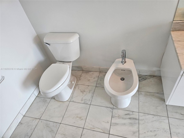 bathroom featuring a bidet and toilet