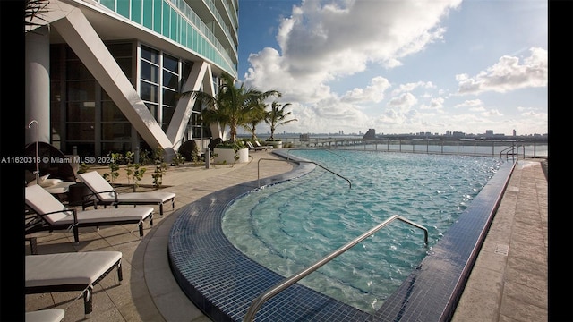 view of swimming pool with a patio