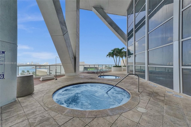 view of pool with a hot tub