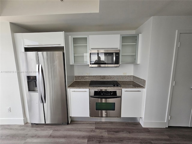 kitchen featuring stainless steel dishwasher, a kitchen island with sink, white cabinetry, dark hardwood / wood-style floors, and a wall of windows