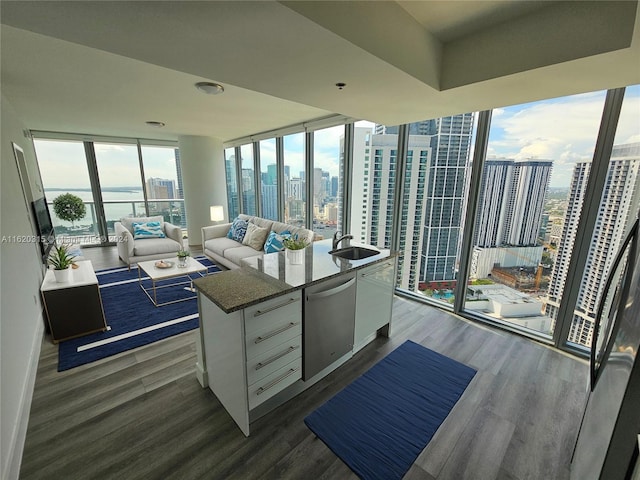 bedroom with a wall of windows, hardwood / wood-style floors, and multiple windows