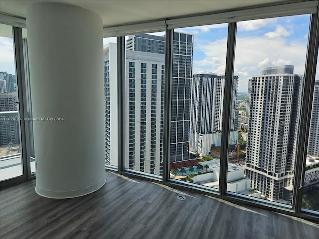 spare room with expansive windows, plenty of natural light, and sink