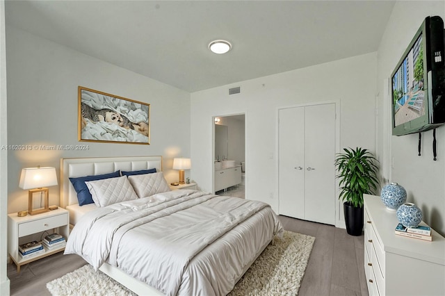 888 Biscayne Blvd Unit 1805, Miami, FL 33132 - bedroom with visible vents, wood finished floors, ensuite bath, and a closet