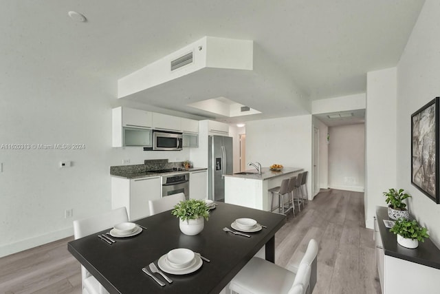 888 Biscayne Blvd Unit 1805, Miami, FL 33132 - dining area featuring visible vents, light wood finished floors, and baseboards