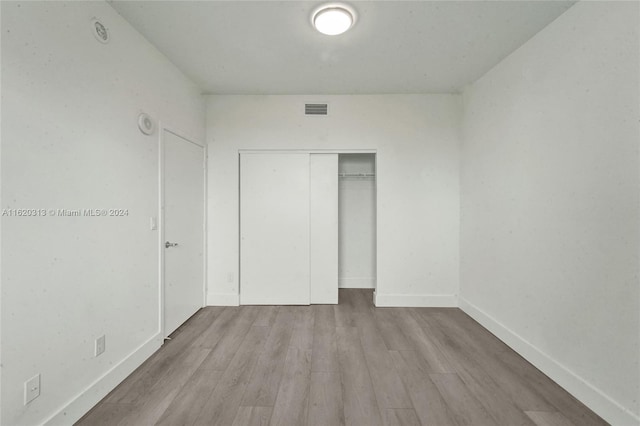 888 Biscayne Blvd Unit 1805, Miami, FL 33132 - unfurnished bedroom with wood finished floors, visible vents, baseboards, and a closet