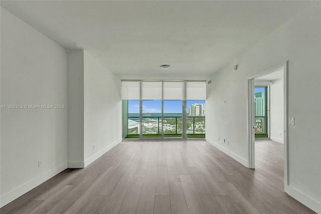 888 Biscayne Blvd Unit 1805, Miami, FL 33132 - empty room with floor to ceiling windows, wood finished floors, and baseboards