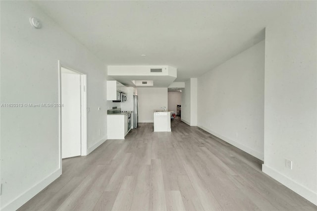888 Biscayne Blvd Unit 1805, Miami, FL 33132 - unfurnished living room with visible vents, baseboards, and light wood-style floors
