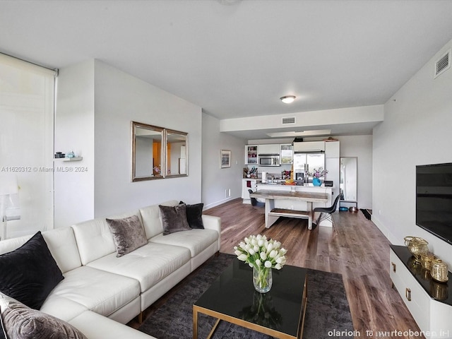 living room with dark hardwood / wood-style flooring