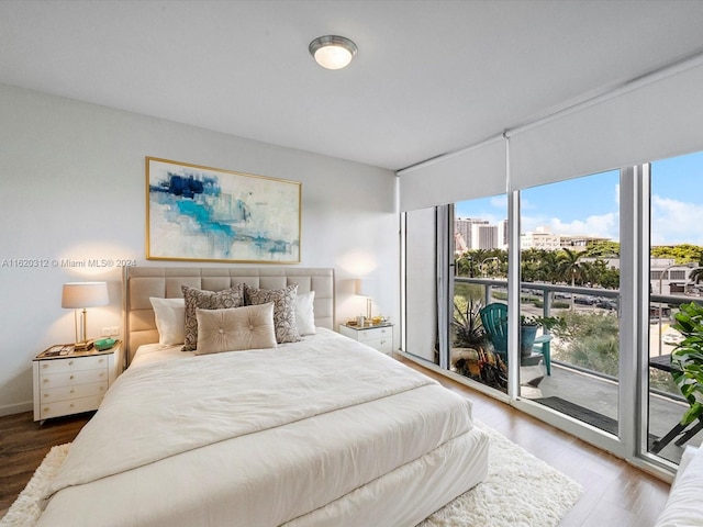 bedroom featuring hardwood / wood-style floors and access to exterior