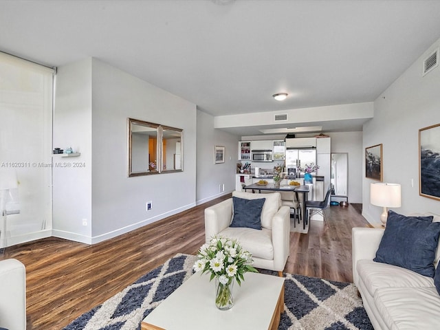 living room with dark hardwood / wood-style floors