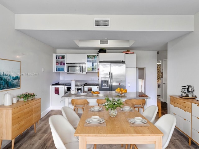 dining space with dark wood-type flooring