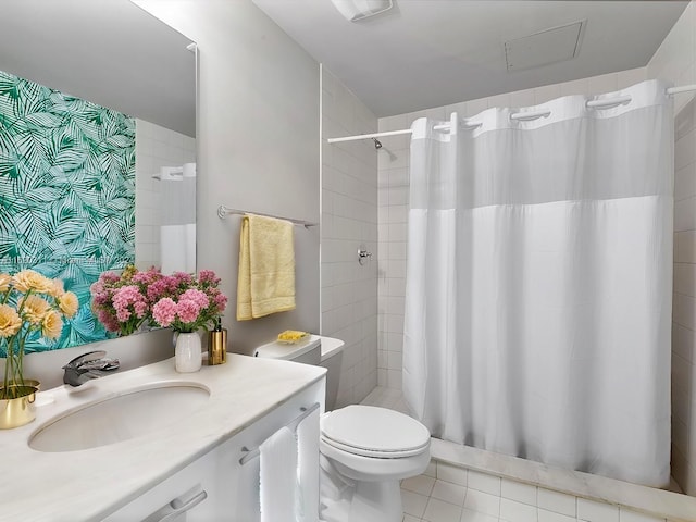 bathroom with toilet, vanity, a shower with shower curtain, and tile patterned floors