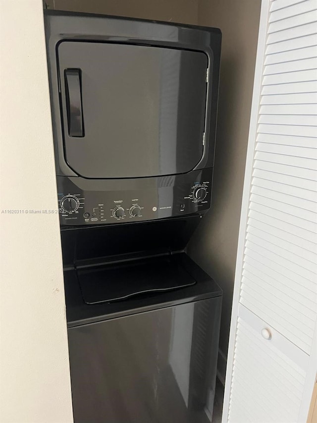 laundry room with stacked washer / drying machine