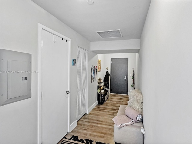 hall with electric panel and light wood-type flooring