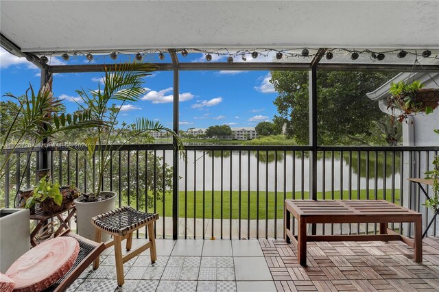 sunroom / solarium with a water view